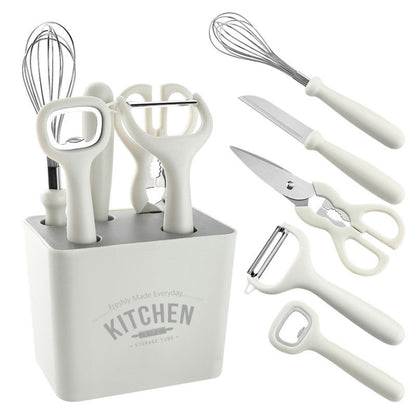 Minimalist white kitchen tool set including whisk, knife, scissors, and peeler with compact storage holder